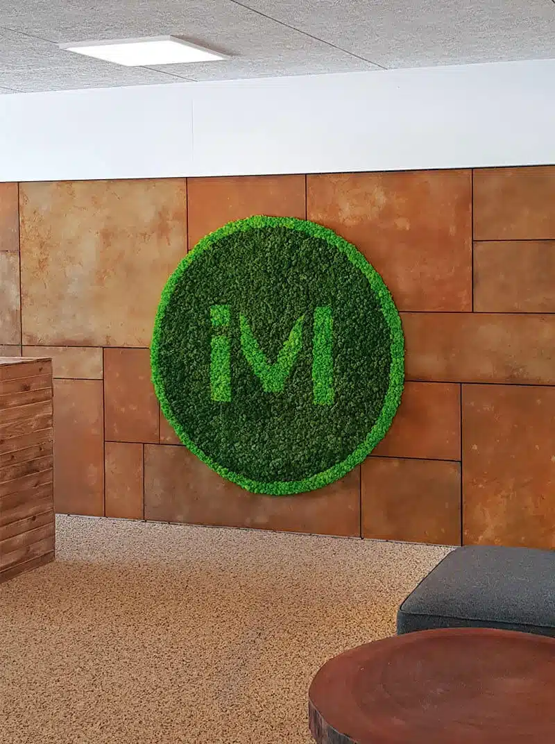 Green logo on brown wall background